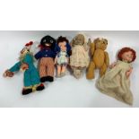 A collection of vintage dolls and soft toys