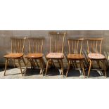 Four mid-20th century Ercol dining chairs, each wi