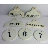 Three circular cream ceramic glazed numbered label