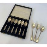 A cased set of six silver coffee spoons; and a mat