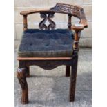 A 20th century oak corner chair, the back and arms