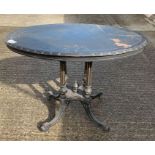 A Victorian ebonised oval centre table, on four re