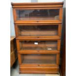 A stained oak four section Globe Wernicke bookcase