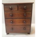 A 20th century stained oak apprentice chest of two