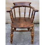 A 20th century stained oak smokers bow chair, with