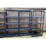 3 black plastic shelving units