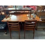 A mid 20th century McIntosh teak extending dining table & 4 chairs
