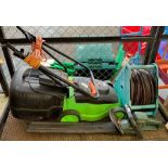 A green electric lawn mower, a Black & Decker elec