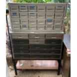 2 metal sets of drawers, some with contents