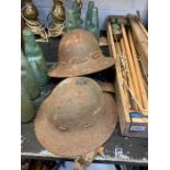 2 military helmets, possibly French, along with a