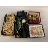 Shelf of costume jewellery, wristwatch, brooches e