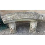 Reconstituted stone garden bench with lion head detailing on the