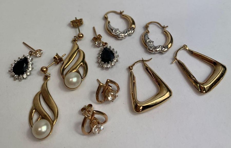 A collection of five pairs of earrings, of various
