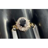 A 9 carat gold sapphire and diamond cluster ring,