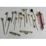 A collection of sixteen stickpins, in a variety of