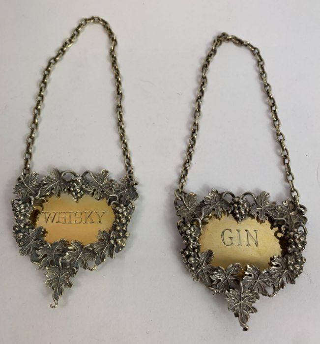 A pair of silver wine labels, by J Figg & Son Ltd,