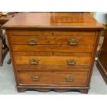 A walnut chest of drawers, set with three long dra