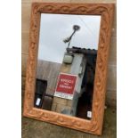 A 20th century stripped pine wall mirror, the bord