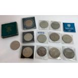 A collection of commemorative coins, some cased