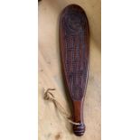 A modern hardwood Maori short paddle with carved d