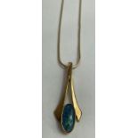A 9 carat gold opal triplet pendant on a chain, po