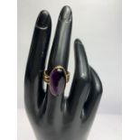 A 9 carat gold cabochon amethyst set ring, finger