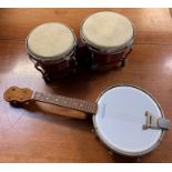 A vintage ukelele, along with a set of bongo drums