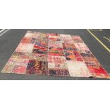 A 20th century patchwork rug, 365cm x 273cm