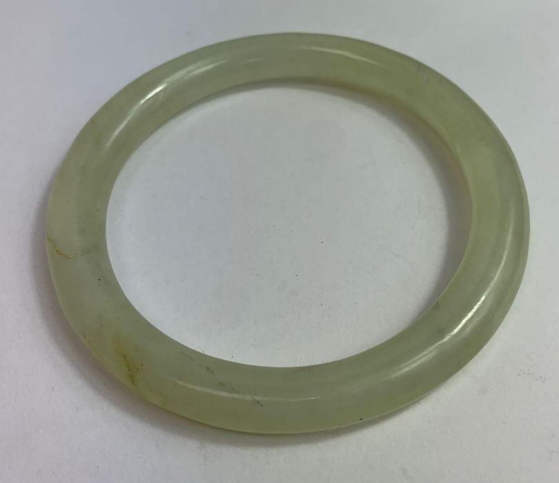 A plain jade bangle, of round section, inner diame - Image 2 of 2