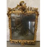 A 19th century ornate gilt framed mirror, the bord