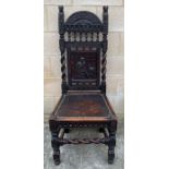 A 19th century oak chair, the back panel carved wi