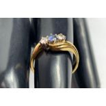 An 18 carat gold three stone diamond and sapphire