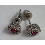 A pair of ruby and diamond cluster ear studs, in u