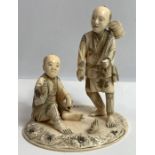 A late 19th century Japanese ivory okimono of two male
