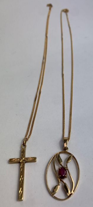 A 9 carat gold ruby set pendant, on a chain, with