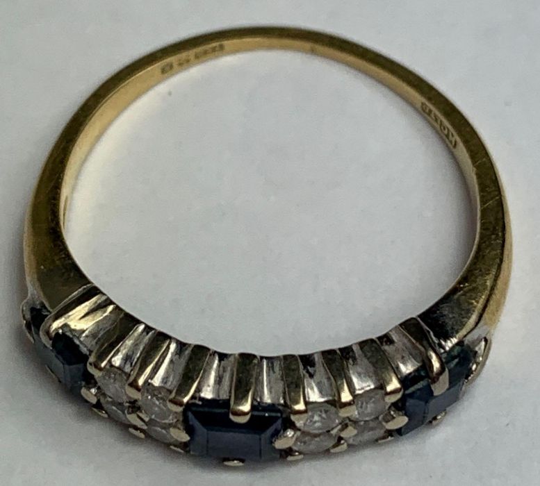 An 18 carat gold sapphire and diamond half hoop ri