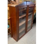 A mahogany display cabinet with two glazed doors,