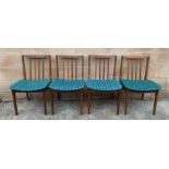 A set of four mid century teak chairs