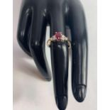 A ruby and diamond ring, unmarked, the oval cut ru