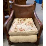 A 20th century leather armchair, the back seat emb