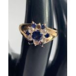 A 9 carat gold cluster ring, of blue and white syn