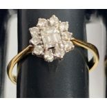 An 18 carat gold diamond cluster ring, the central