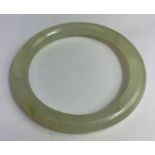 A plain jade bangle, of round section, inner diame