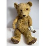 A 20th century vintage golden teddy bear, 55cm lon