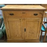 A Victorian pine cupboard with a single long drawe