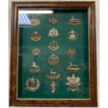 A framed display of military badges to include Glo