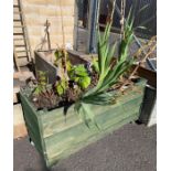 Wooden trough planter including plants