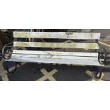 Wrought iron framed garden bench with white painte