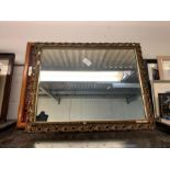 Gilt frame wall mirror and a display case of spoon