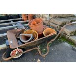 Metal wheelbarrow along with terracotta & glazed p